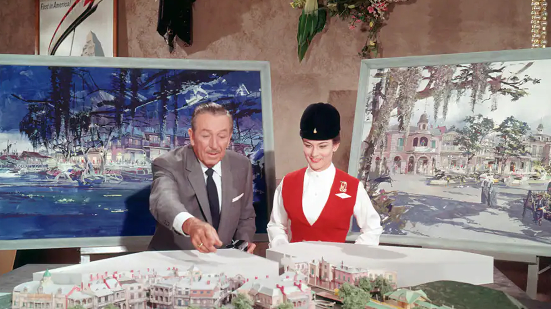 Walt Disney standing with Disneyland Ambassador