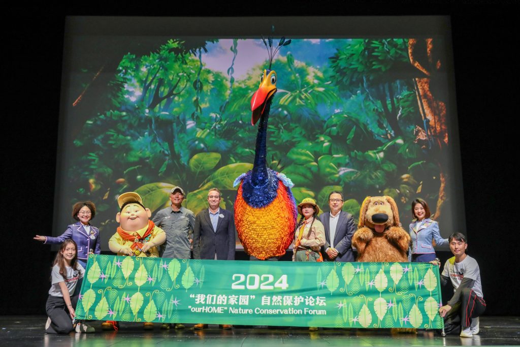 Group poses with characters from Pixar's 