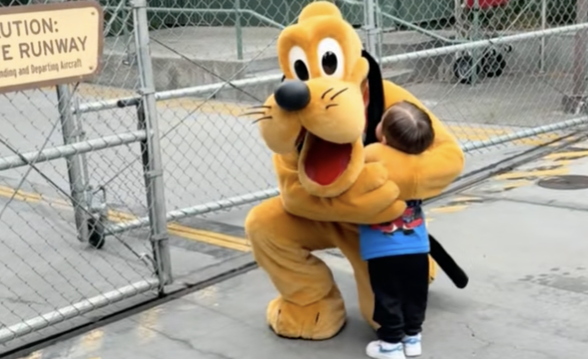 Little boy hugging Pluto