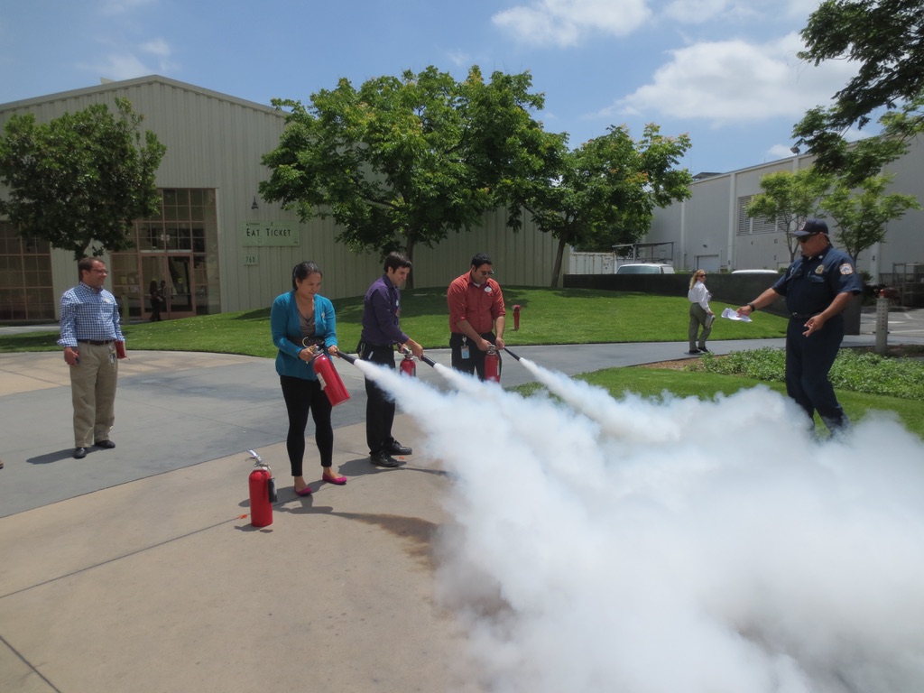 Cast members put their learnings to the test, practicing the PASS method using a real fire extinguisher. 