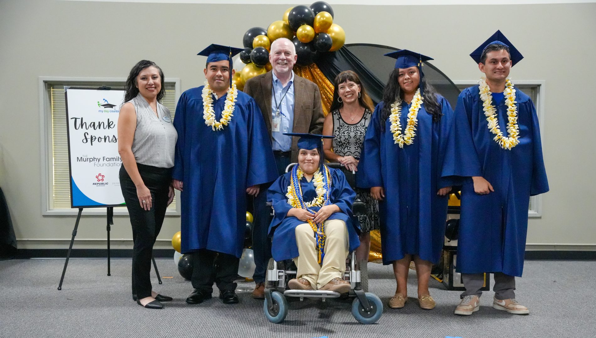 My Day Counts program participants smile at their high school graduation.