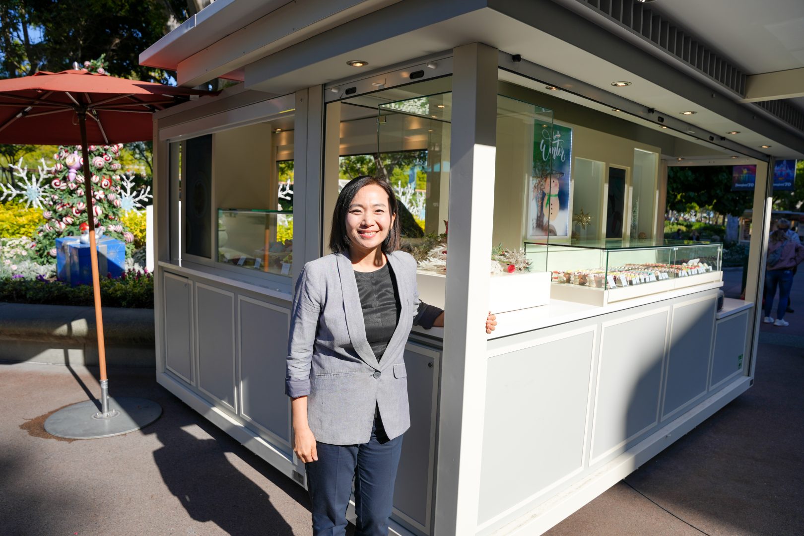 Kayla proudly smiles at the newly reimagined Kayla’s Cake cart in Downtown Disney District.