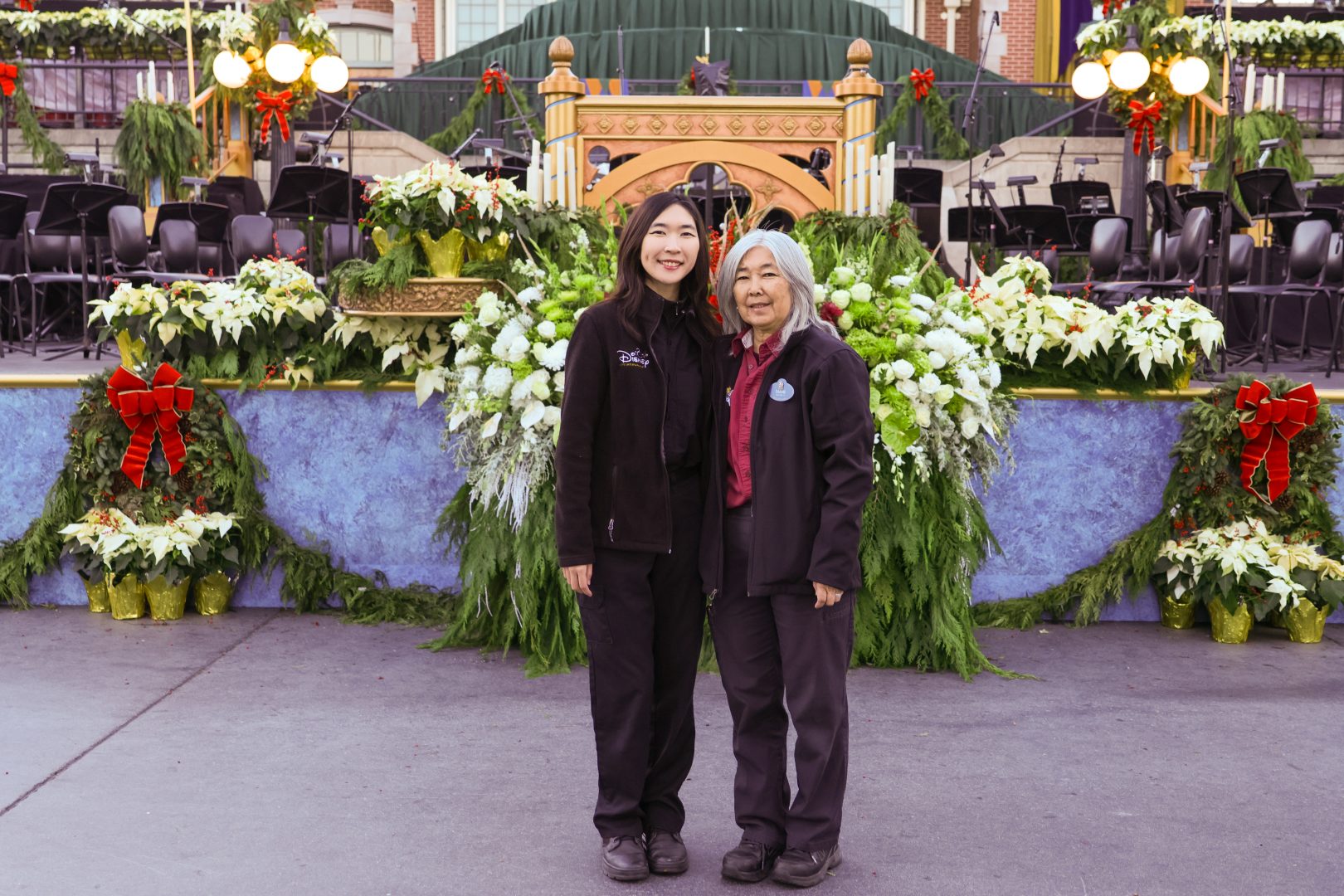 Diane and Mary working together with the live florals they love so much on the Candlelight Processional stage.