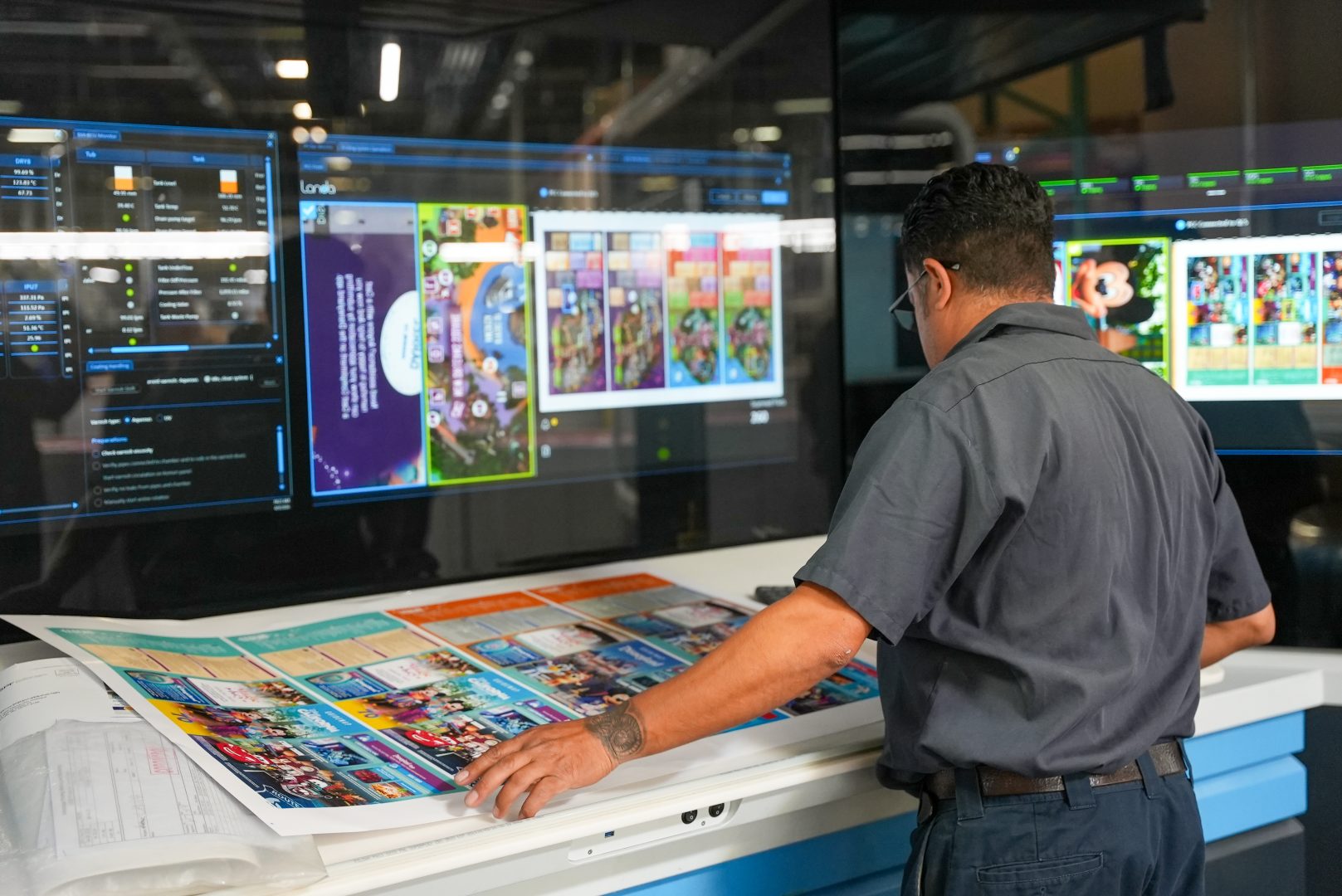 A team member reviews one of the first map prints of the day.