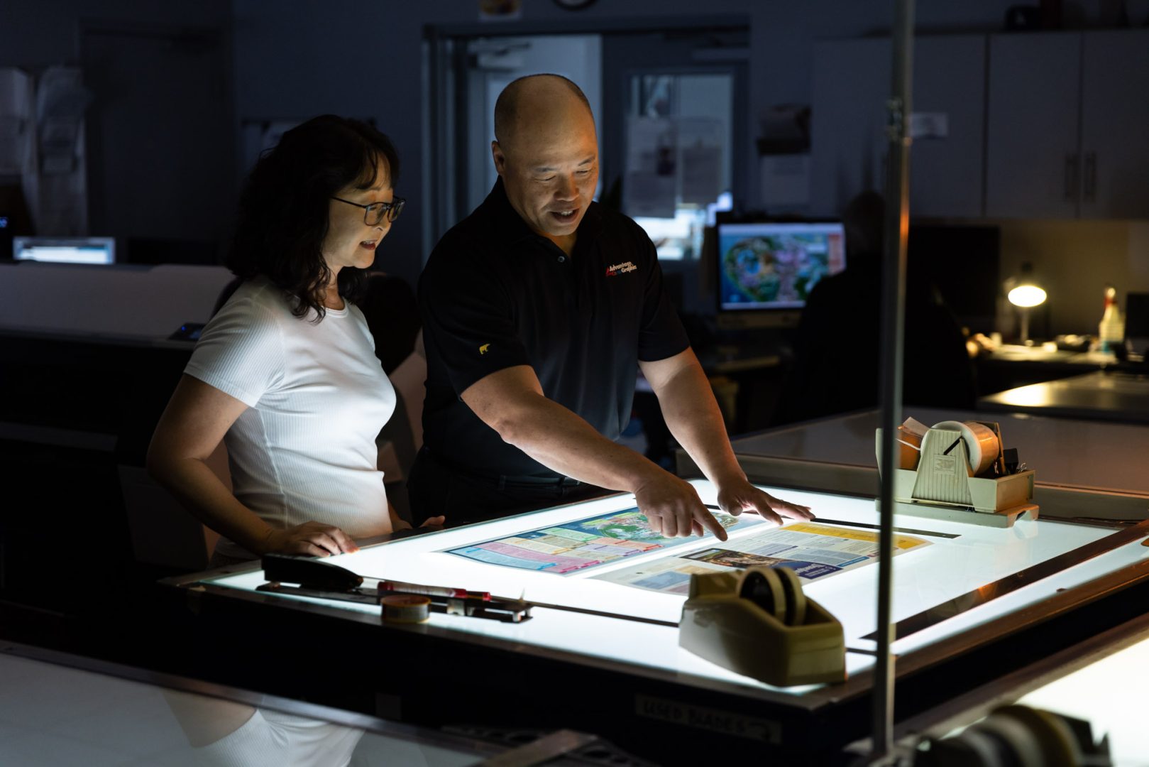 Tom (right) works with one of his team members on refining a recent map design.