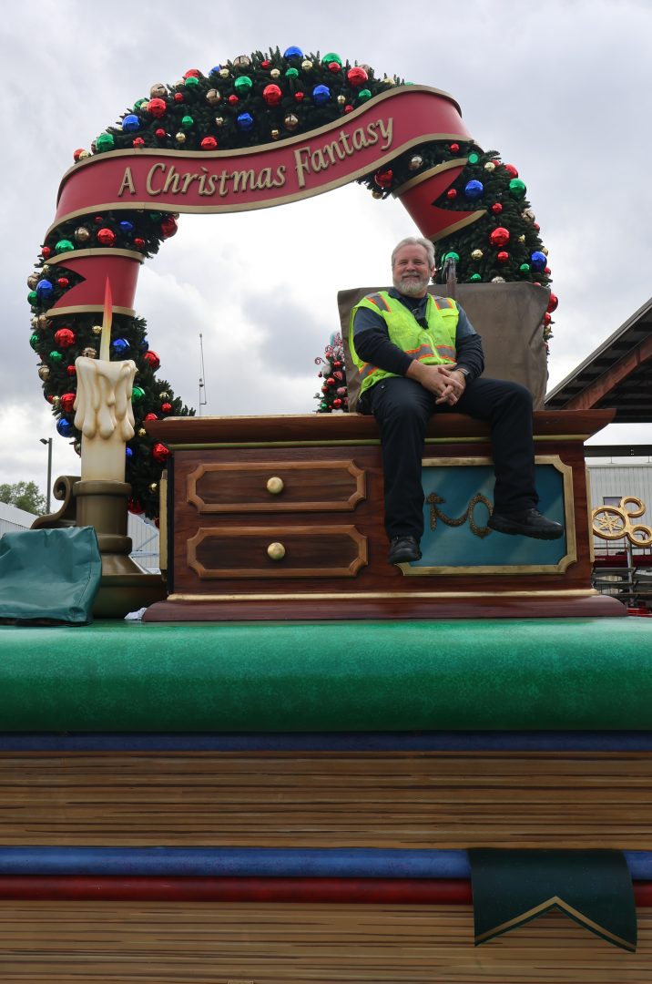 Ken and Christine posing on floats they have driven in "A Christmas Fantasy Parade" this season.